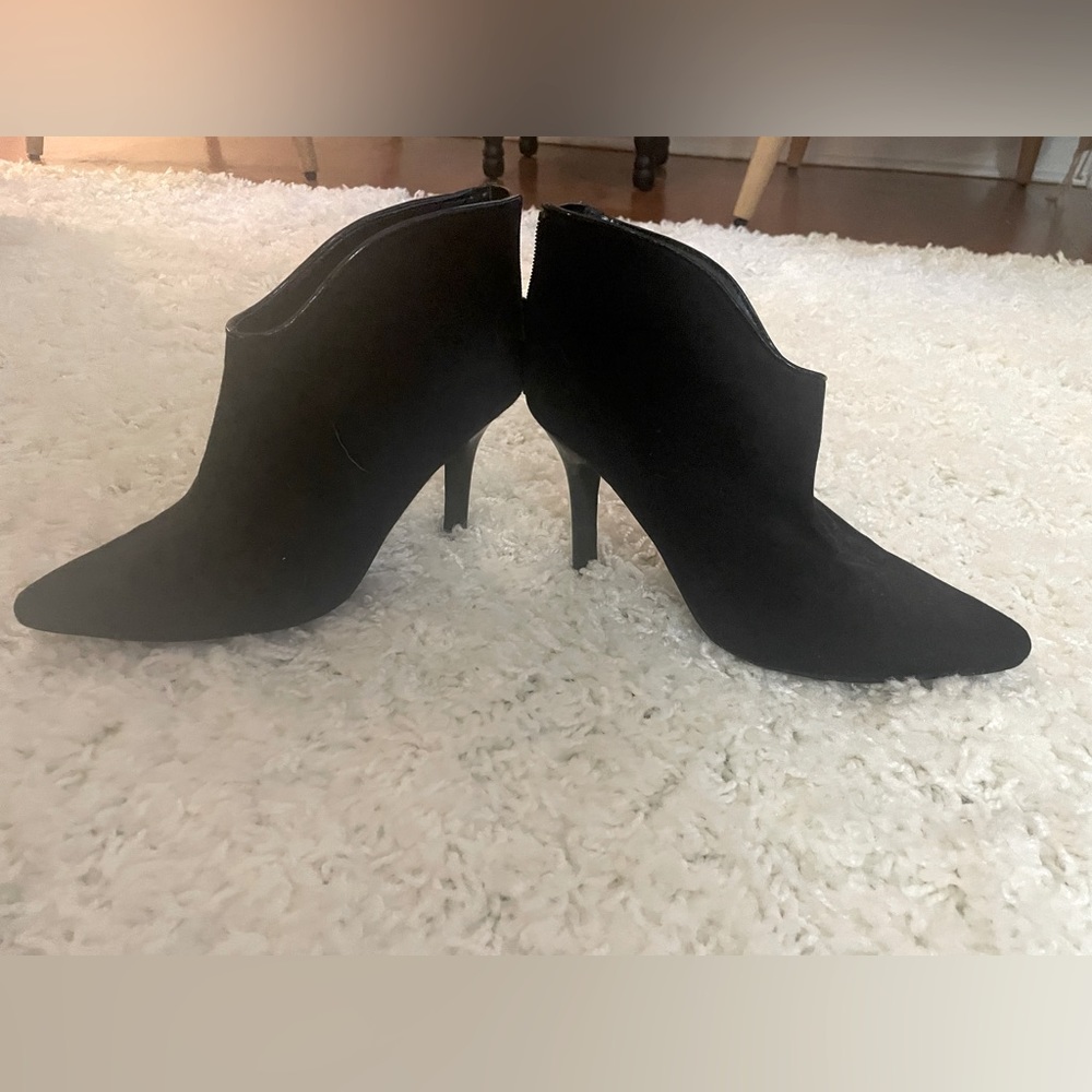 Black suede booties by Carlos Santana
